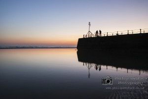 Fishermen on the groyne after sunset Hove